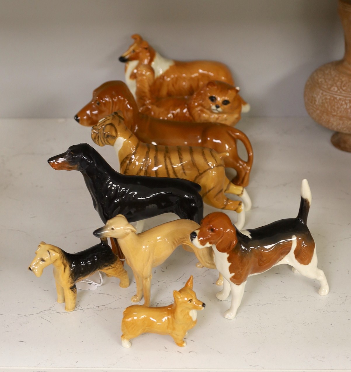 A selection of Beswick dogs, to include a Corgi, Daschund, Lurcher, Beagle, Doberman, Fox Terrier, Lochinvar of Ladypark, together with a Beswick cat (9)